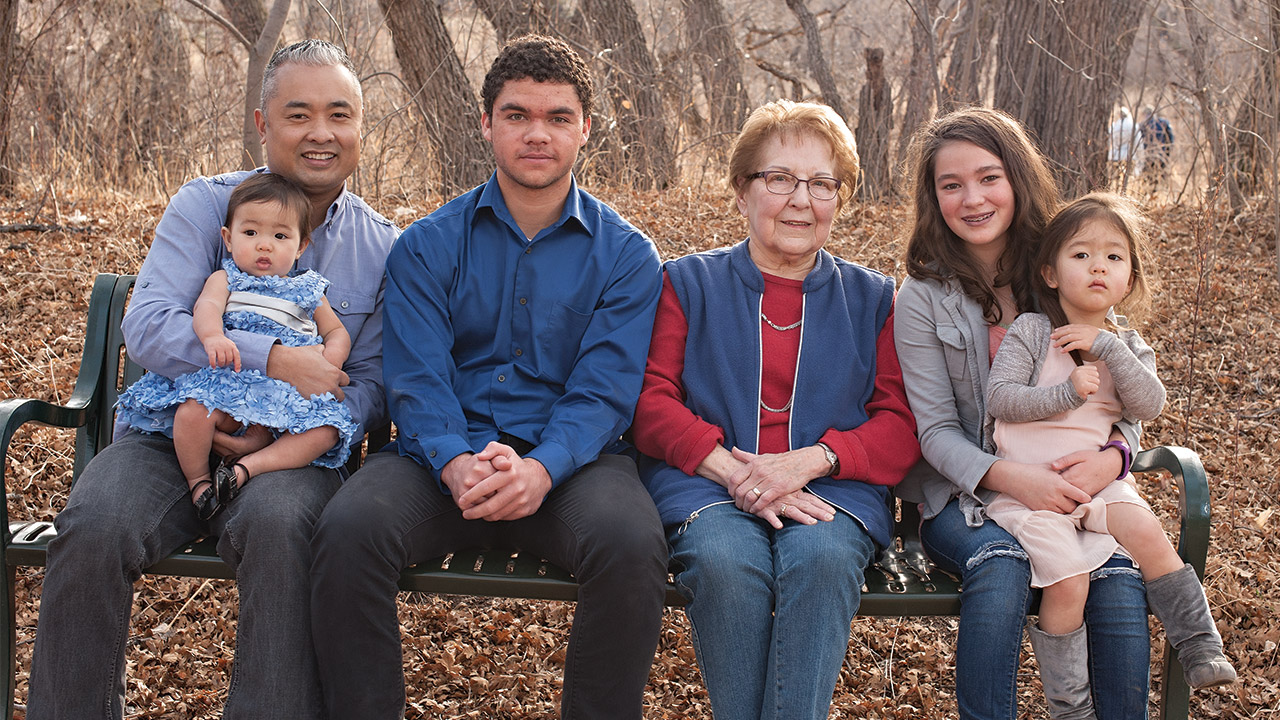 group of people sitting on a park bench in the Fall